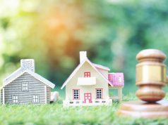 alt="Property auction, Model house and Gavel wooden on natural green background, lawyer of home real estate and ownership property concept"