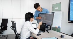 Engineers reviewing code on a monitor: Due Diligence on a Public-Record API: The Groundwork That Comes First
