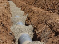 Who Owns the Drain? A Plain Guide to Drain Responsibility for UK Homeowners Drainage pipe laid on a gravel bed in an open trench